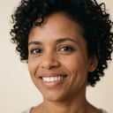 Mia, a 28-year-old woman of short stature with curly black hair and a bright smile