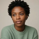 Portrait of Amara, a Black woman with autism and a calm expression