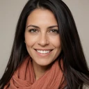 Portrait of Isabella, a Latina deaf woman smiling warmly