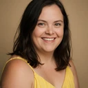 Portrait of Sarah, a woman with Down syndrome smiling warmly